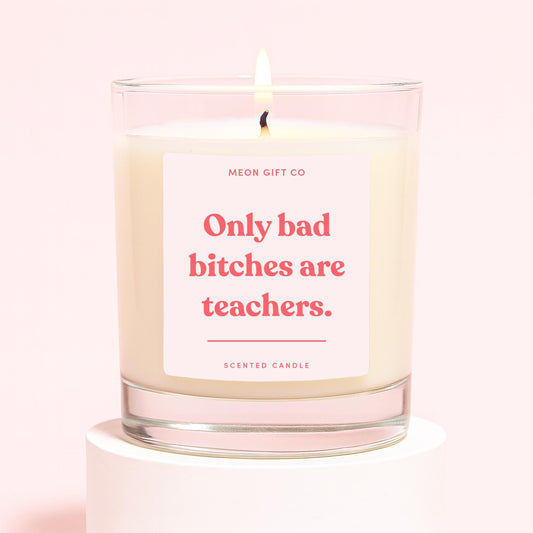 Glass jar scented candle with centered quote label and lit wick
