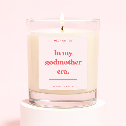 Scented candle in clear glass with cream wax and 'In my godmother era' label