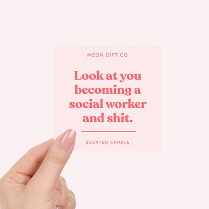 Hand holds card for scented candle; reads 'Look at you becoming a social worker and shit.'