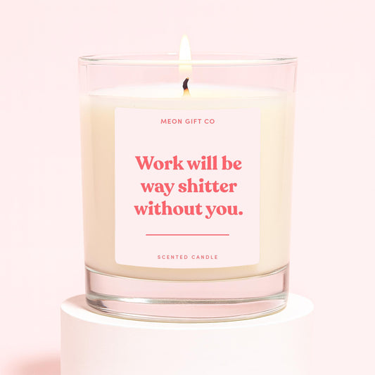 Scented candle in clear glass jar with lit wick and cream wax, red quote label—MEON GIFT CO