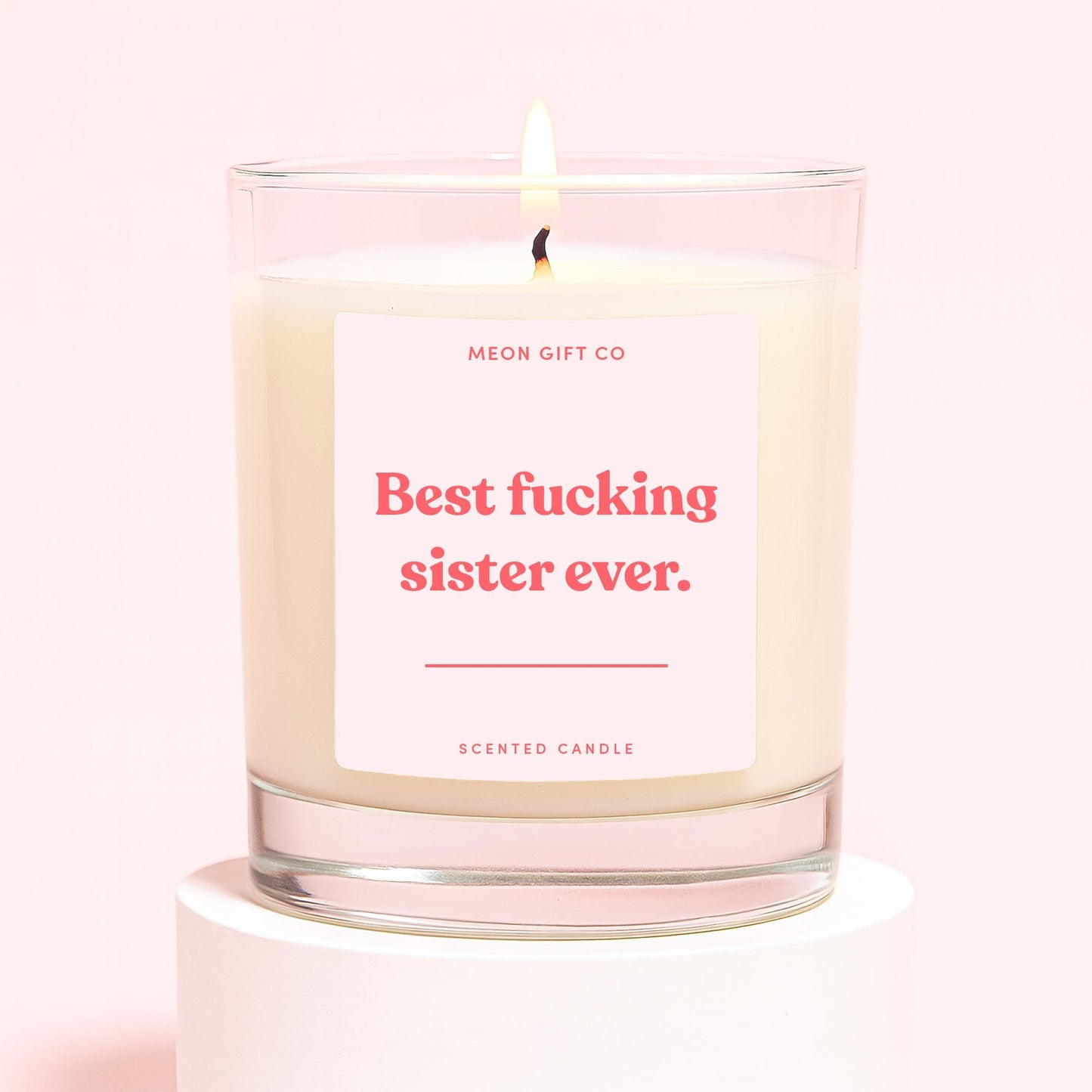 Glass scented candle with cream wax, label: 'Best fucking sister ever.'