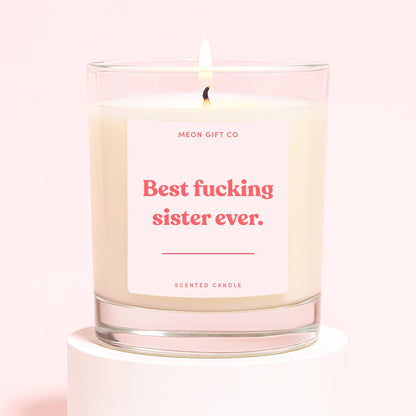 Glass scented candle with cream wax, label: 'Best fucking sister ever.'