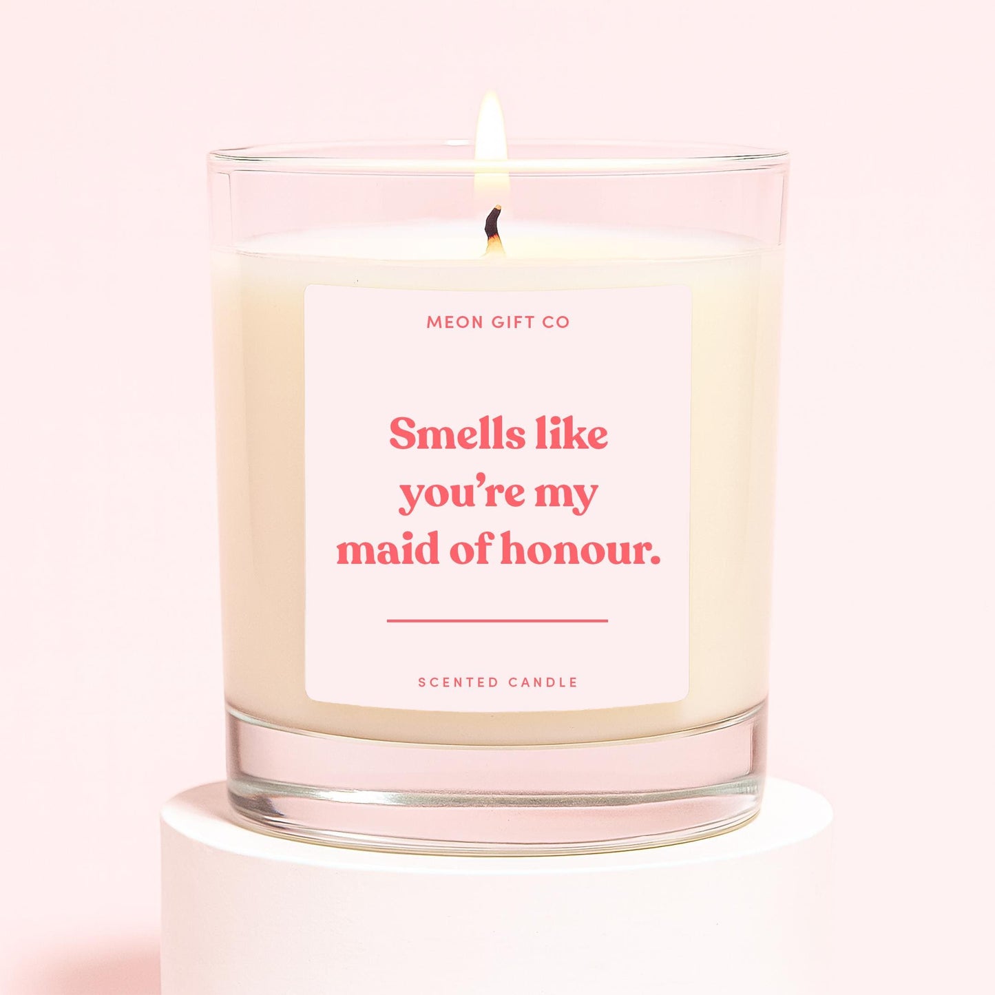 Scented candle in clear glass jar with cream wax, label 'Smells like you're my maid of honour.'