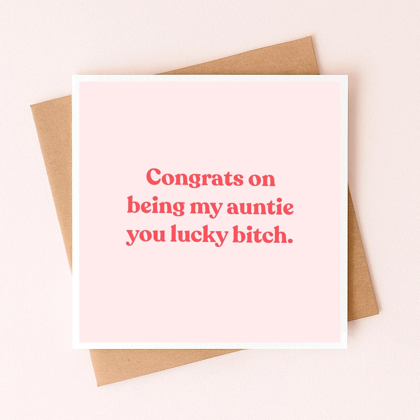 Greeting card with red 'Congrats on being my auntie' message on pale pink front