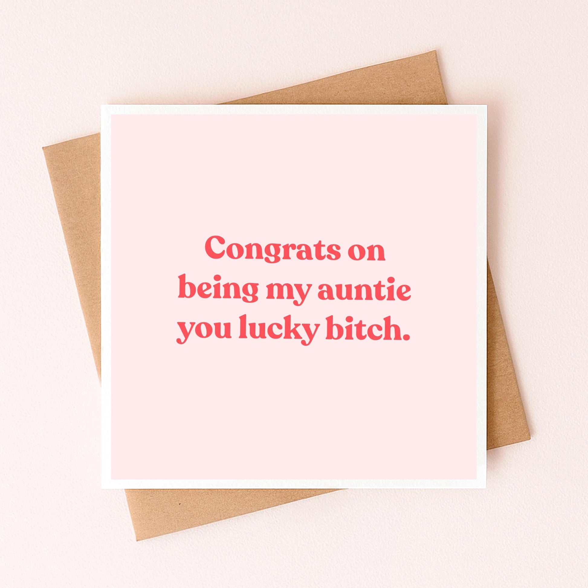 Greeting card with red 'Congrats on being my auntie' message on pale pink front
