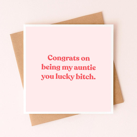Greeting card with red 'Congrats on being my auntie' message on pale pink front